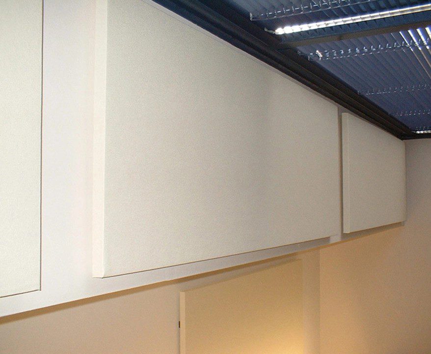 Fabric-wrapped acoustic panels mounted on a wall to enhance sound quality and reduce noise in a professional workspace.