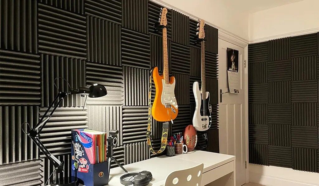 Foam acoustic panels mounted on a wall to control sound and improve acoustic quality in a recording studio.