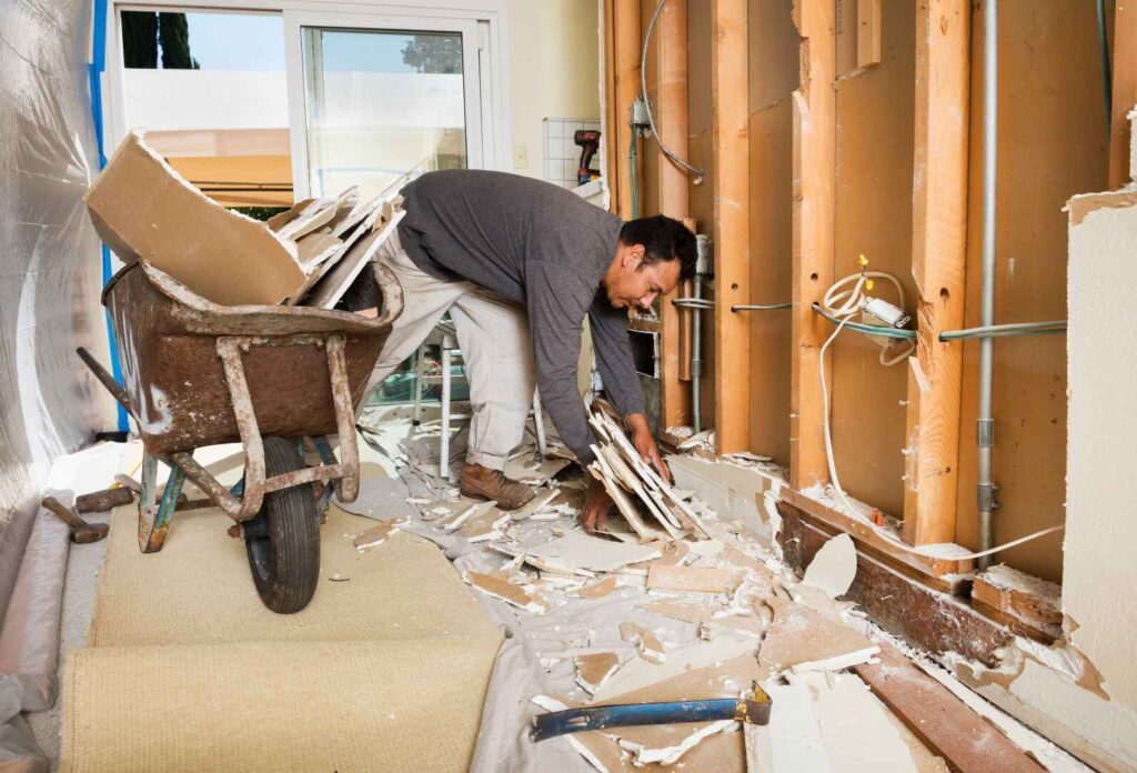 Construction workers carrying out office demolition with heavy machinery in a commercial building.