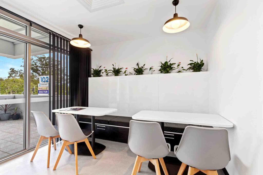 A biophilic office with lush indoor plants, natural wood furnishings, and abundant natural light, enhancing the workspace with nature-inspired elements.