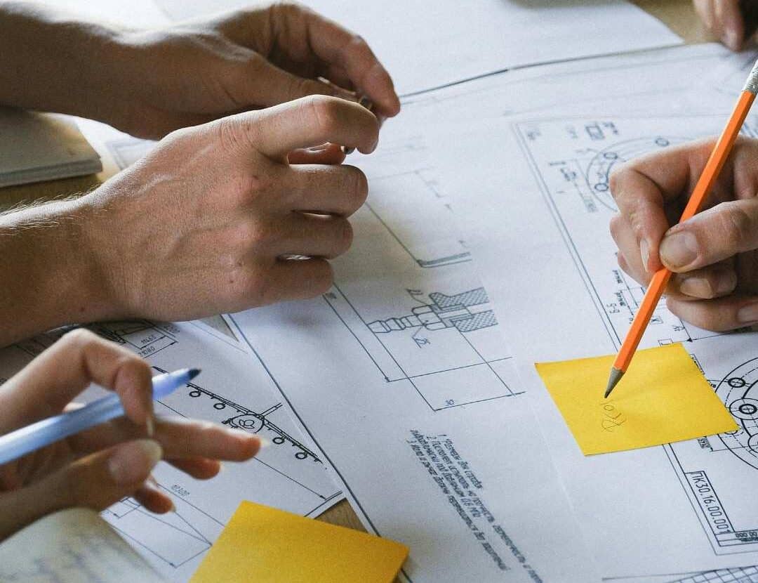 Design team collaborating on retail fitout floor plans and layout concepts, reviewing architectural drawings to optimise space planning and functionality.